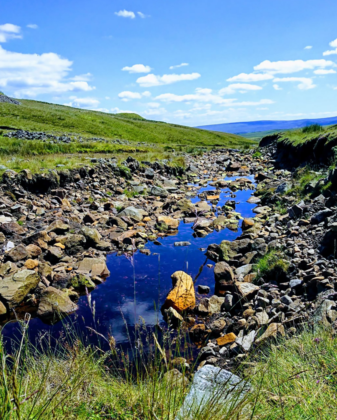 our-story-stream-running-through-hills-dales